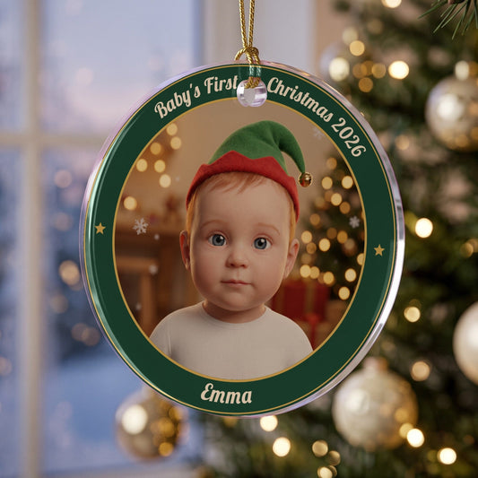 Baby's First Christmas Little Elf photo ornament in an evergreen name ring, hanging from a gold cord on a Christmas tree
