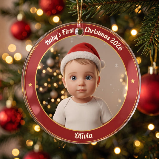Baby's First Christmas Little Santa photo ornament in a red name ring, hanging from a gold cord on a Christmas tree